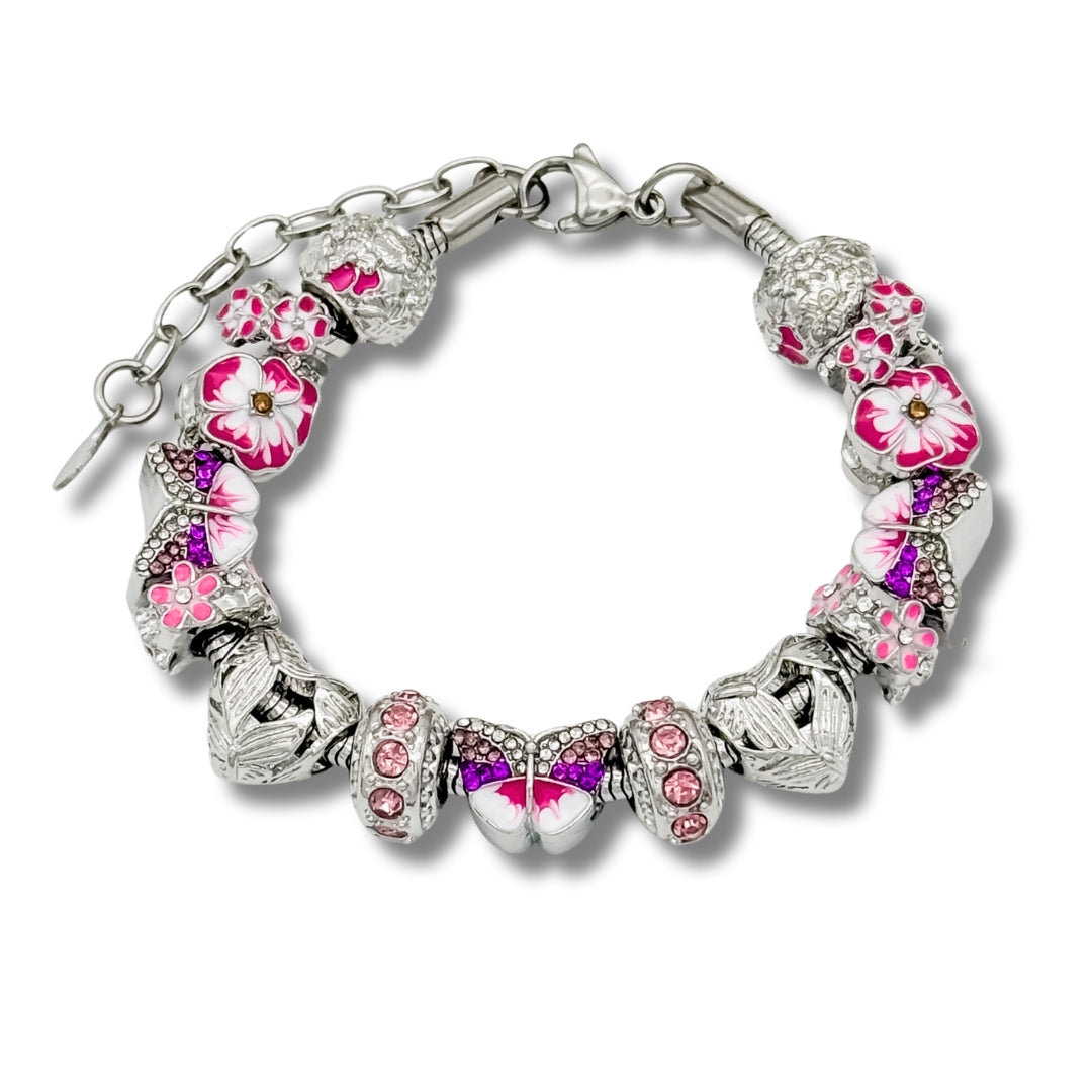 A detailed silver charm bracelet with flower and heart charms on a